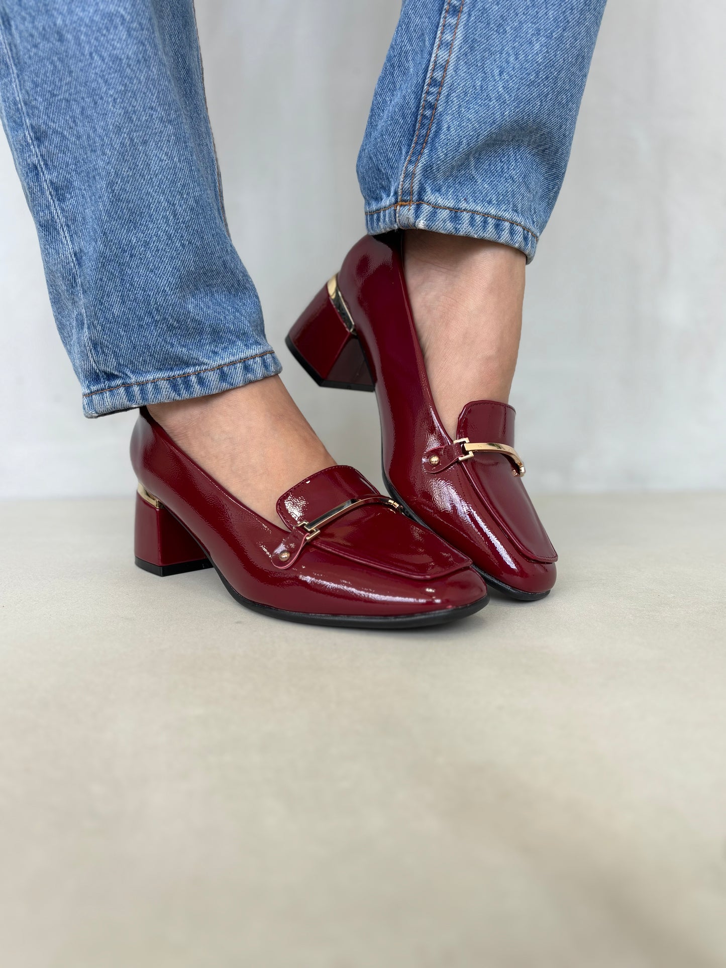 14257 – Zapatos burdeos de tacón medio con acabado charol y detalle dorado para dama