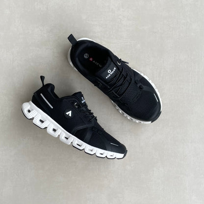 14291 – Tenis Deportivos Negros con Suela Blanca y Tecnología de Amortiguación